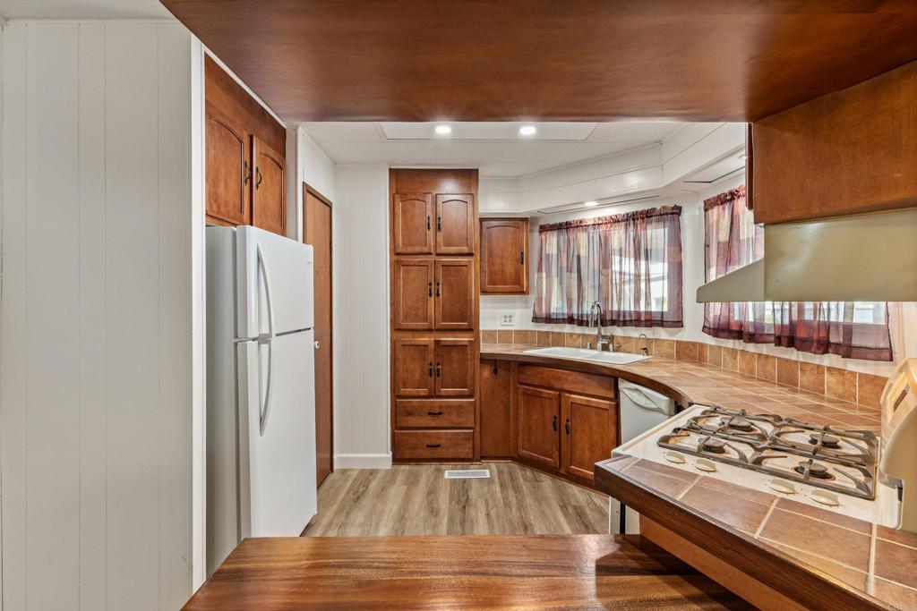 650 South Rancho Santa Fe Road, Unit 312 San Marcos, CA 92078 - Photo 13 of 53 a kitchen with stainless steel appliances granite countertop a stove and a refrigerator