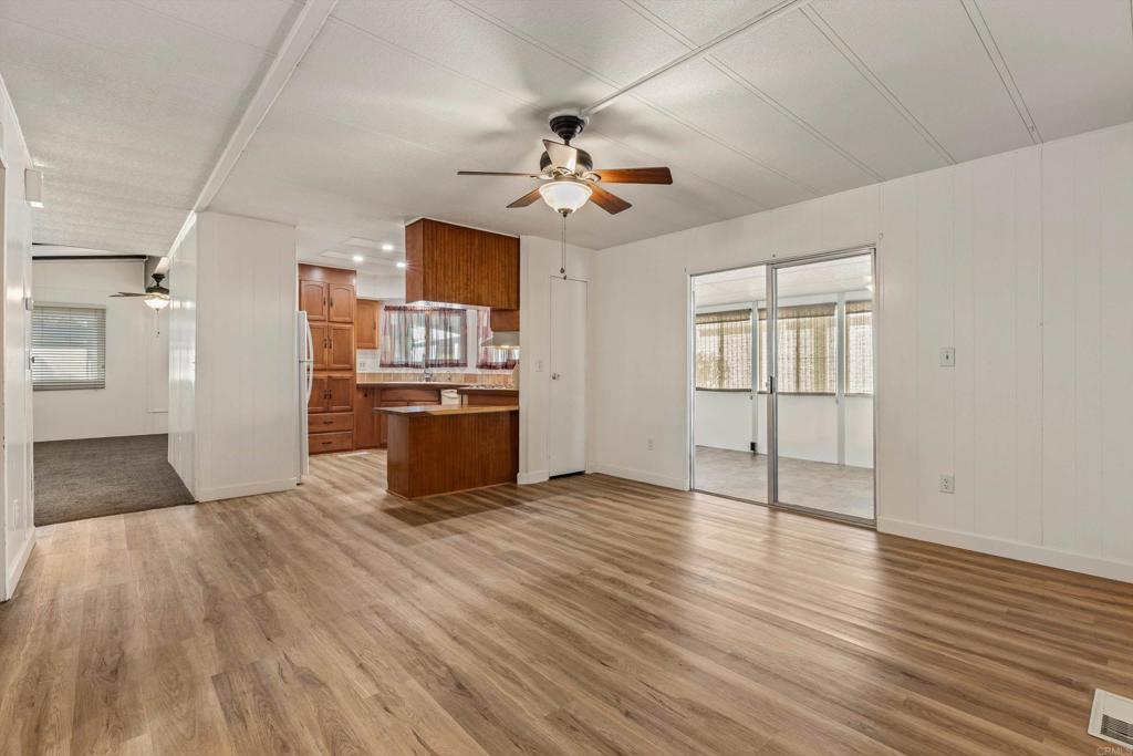 650 South Rancho Santa Fe Road, Unit 312 San Marcos, CA 92078 - Photo 18 of 53 a view of a kitchen with wooden floor a sink a refrigerator and window