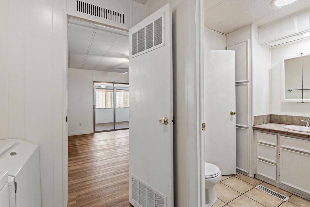 650 South Rancho Santa Fe Road, Unit 312 San Marcos, CA 92078 - Photo 29 of 53 a bathroom with a granite countertop sink toilet and shower
