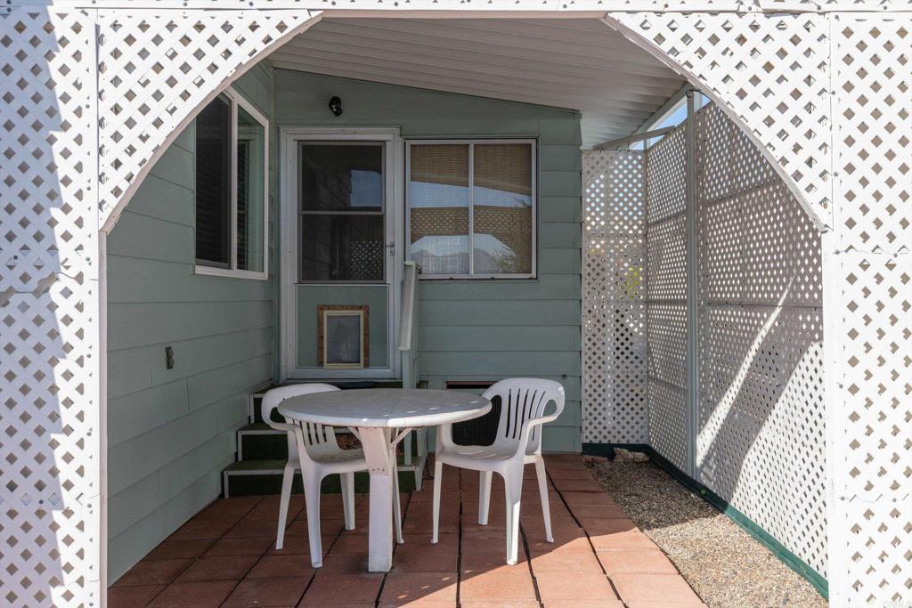 650 South Rancho Santa Fe Road, Unit 312 San Marcos, CA 92078 - Photo 3 of 53 a front view of a house with table and chairs