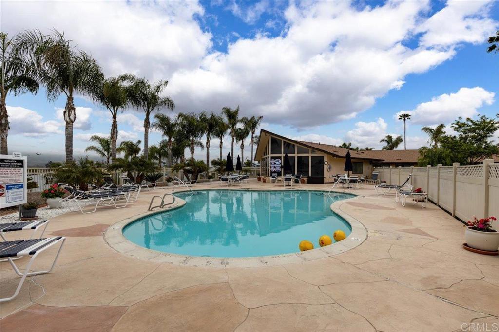 650 South Rancho Santa Fe Road, Unit 312 San Marcos, CA 92078 - Photo 40 of 53 a view of a house with swimming pool and sitting area