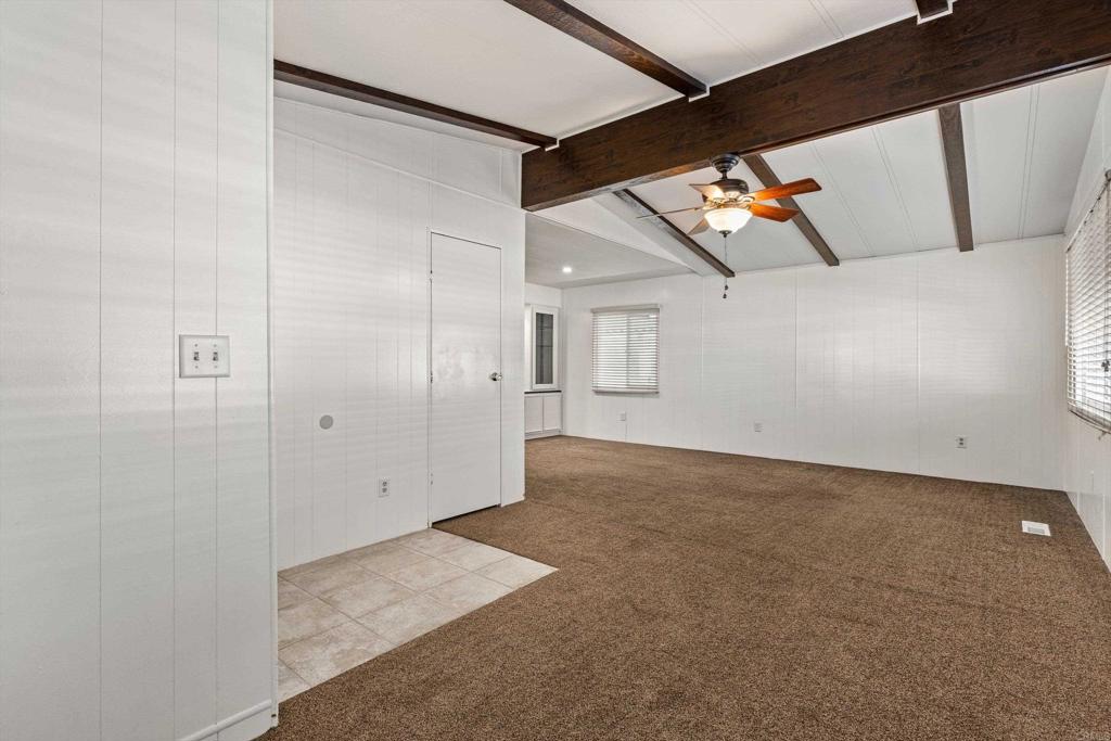 650 South Rancho Santa Fe Road, Unit 312 San Marcos, CA 92078 - Photo 6 of 53 an empty room with wooden floor and windows