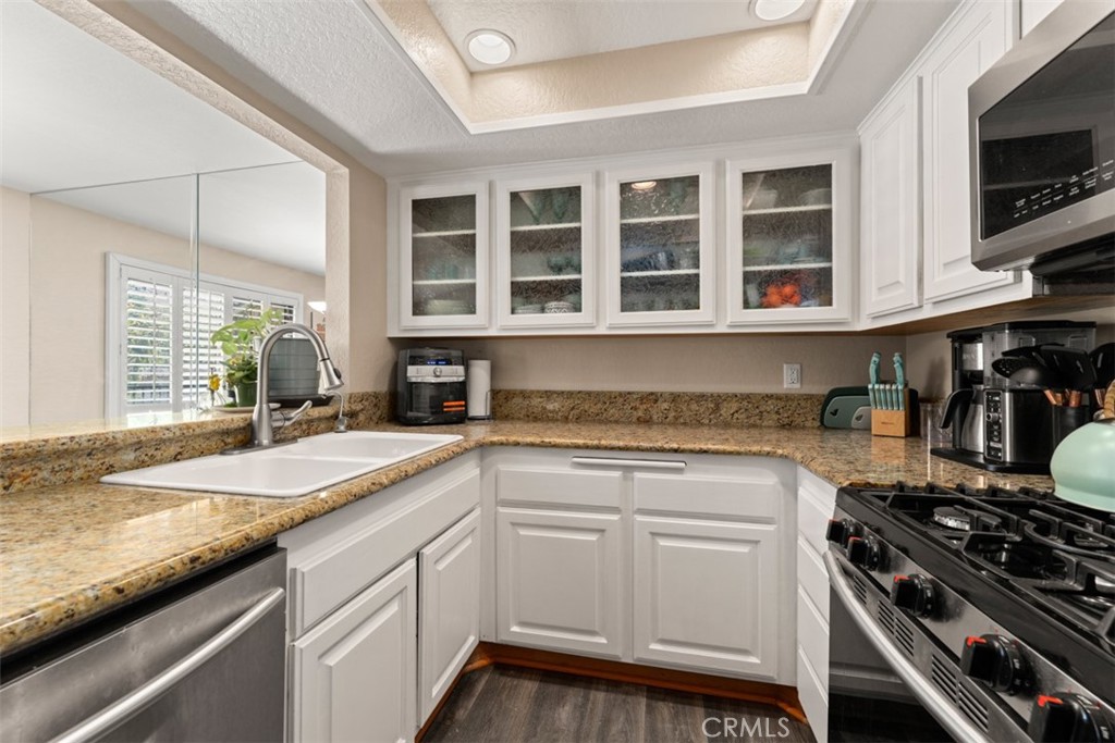 600 Central Avenue, Unit 292 Riverside, CA 92507 - Photo 1 of 1 a kitchen with granite countertop a sink stainless steel appliances and cabinets