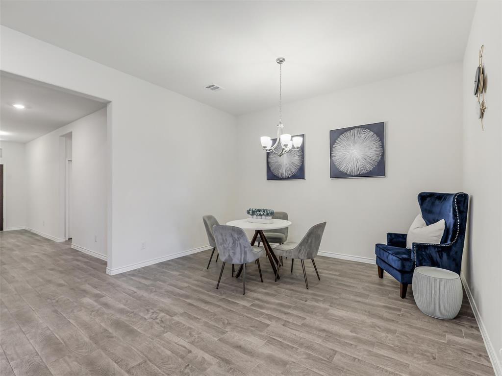 3024 Meredith Lane Forney, TX 75126 - Photo 8 of 29 Spacious interior featuring wood-finish flooring, recessed lighting, and a contemporary chandelier