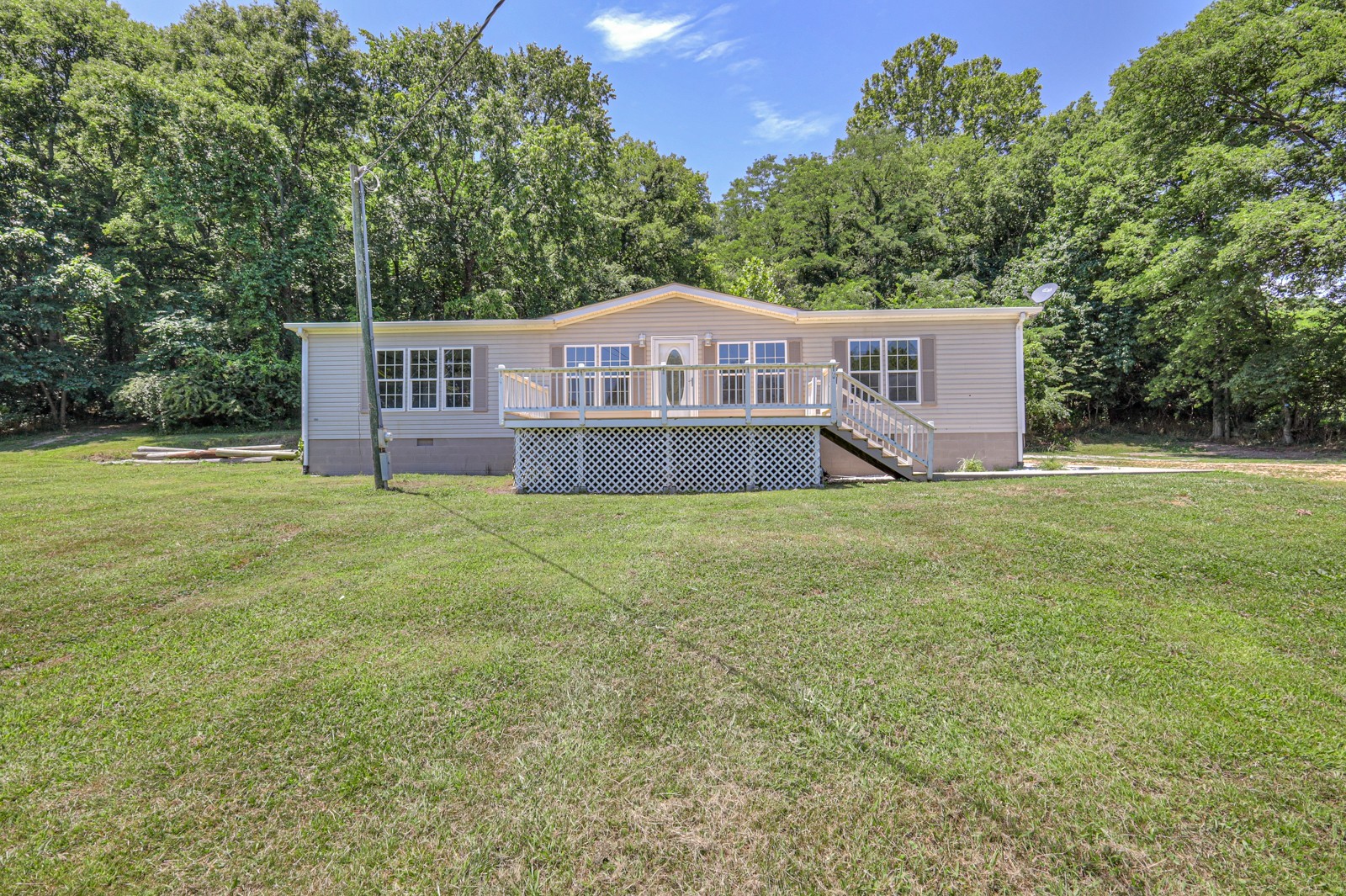a front view of a house with yard and green space
