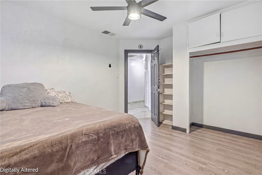 1054 West 24th Street Merced, CA 95340 - Photo 14 of 39 a bedroom with a bed and a walk in closet