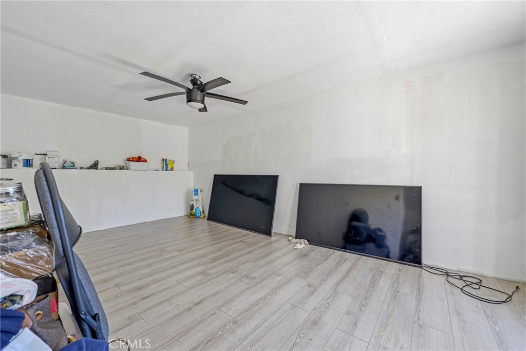 1054 West 24th Street Merced, CA 95340 - Photo 29 of 39 a bedroom with a bed and a chandelier