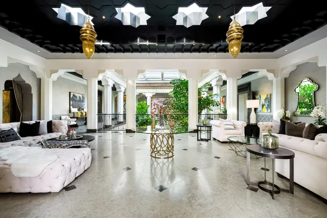 a living room with furniture flowers and a chandelier