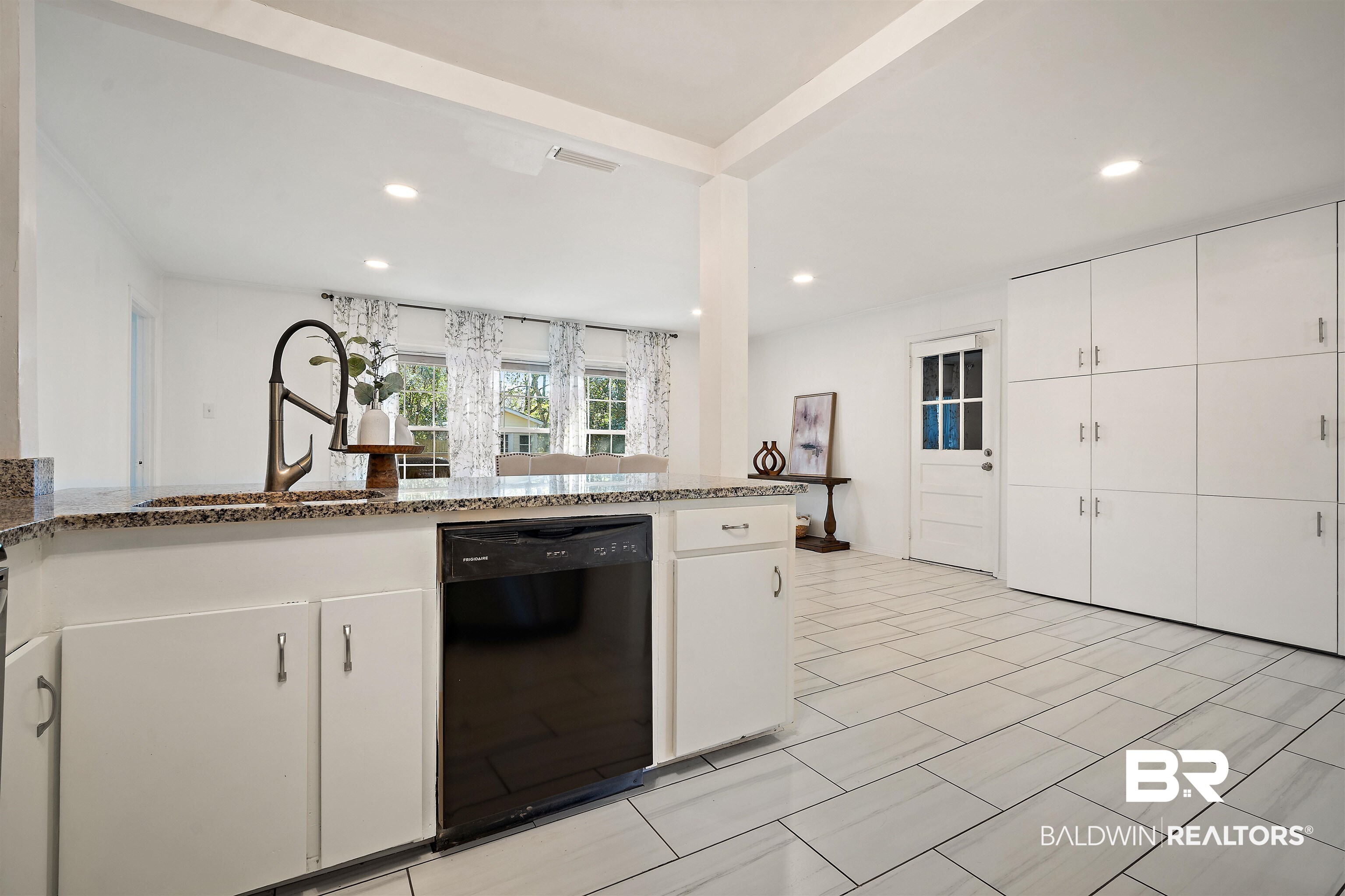 2615 Walton Avenue Mobile, AL 36606 - Photo 9 of 33 Kitchen featuring visible vents, dishwasher, a sink, and white cabinetry