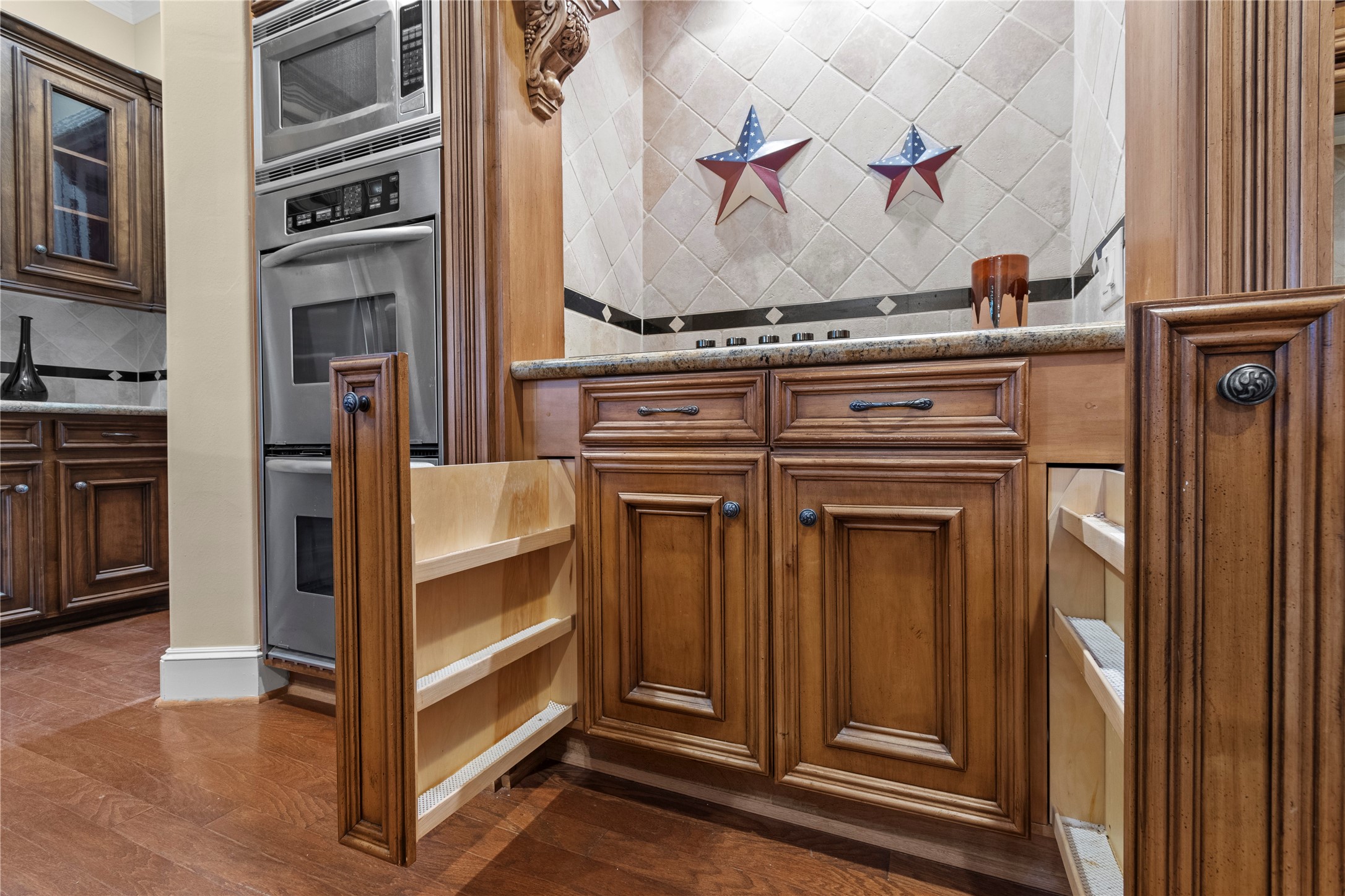 16626 Lafone Drive Spring, TX 77379 - Photo 11 of 42 These pull-out spice drawers are only a few of the custom designed kitchen accessories.