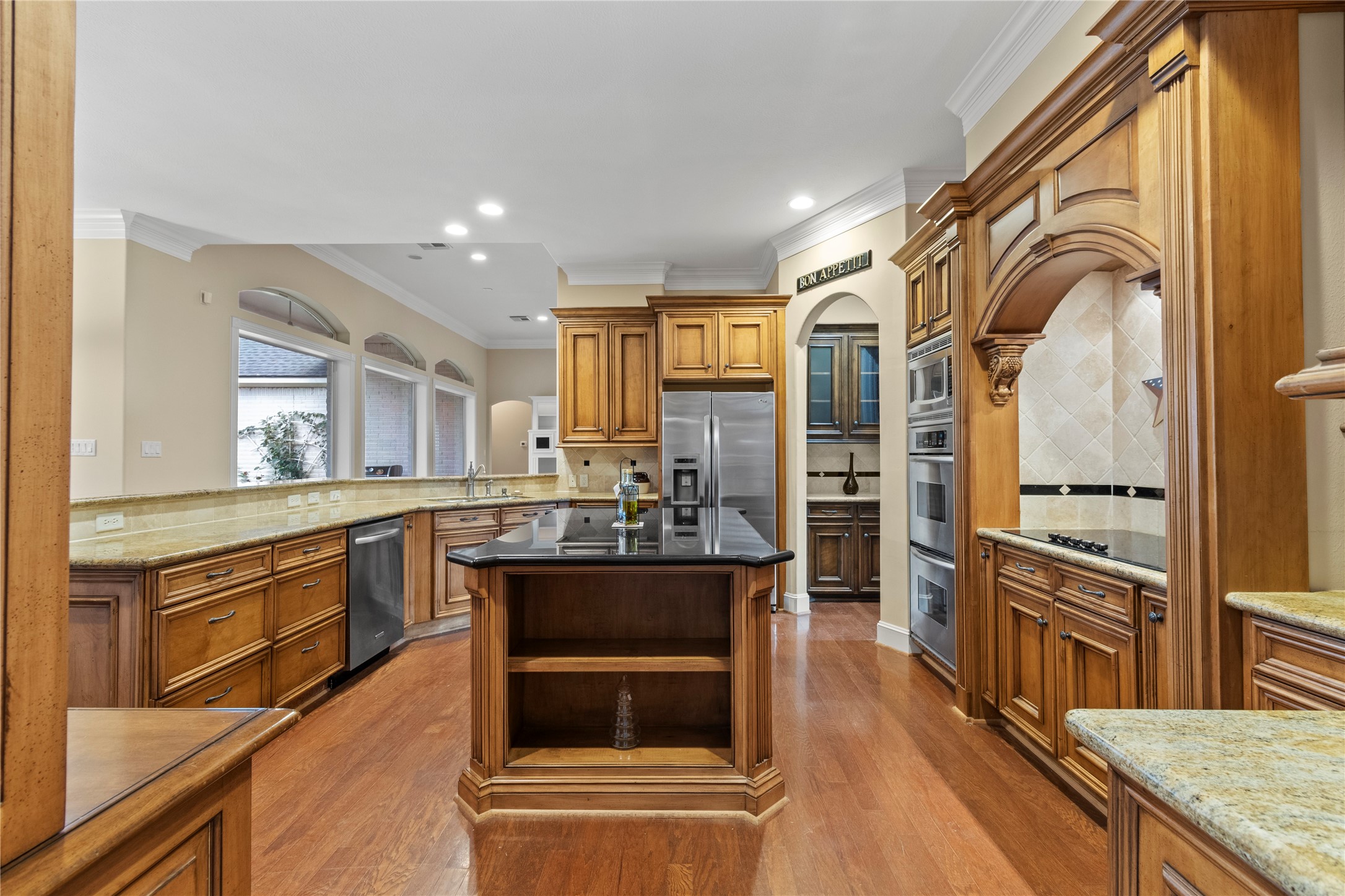 16626 Lafone Drive Spring, TX 77379 - Photo 9 of 42 View of the kitchen coming in from the garage. The island - perfect for prep cooking -- also includes pull out trash, a warming drawer and storage drawers. Fridge and utility room frisge stay.