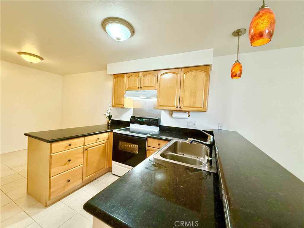 5965 Peacock Ridge Road, Unit 301 Rancho Palos Verdes, CA 90275 - Photo 13 of 31 a kitchen with granite countertop a sink and a stove