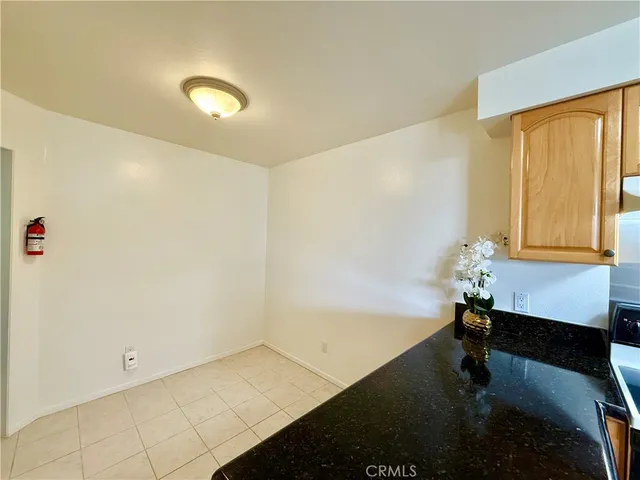 a view of a room with a wooden floor and white walls