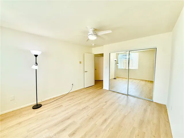 a view of a room with wooden floor and white walls