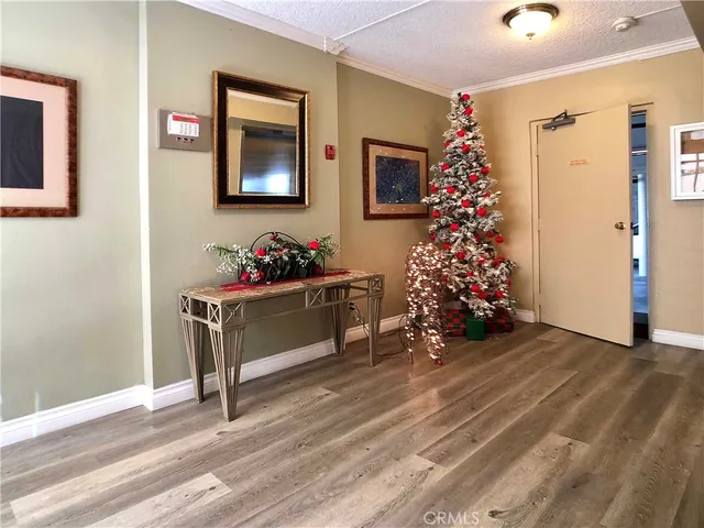 a view of an empty room with a fireplace and a window