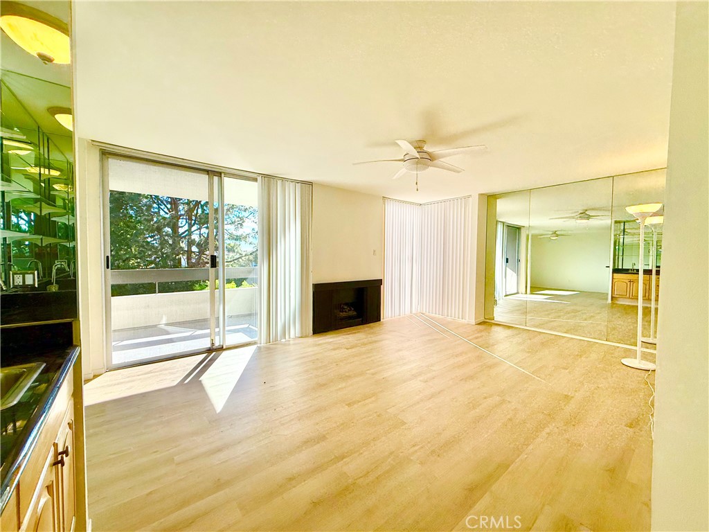 5965 Peacock Ridge Road, Unit 301 Rancho Palos Verdes, CA 90275 - Photo 5 of 31 a view of an empty room with a fireplace and a window
