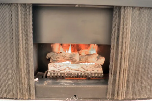 a kitchen with granite countertop a sink and white cabinets