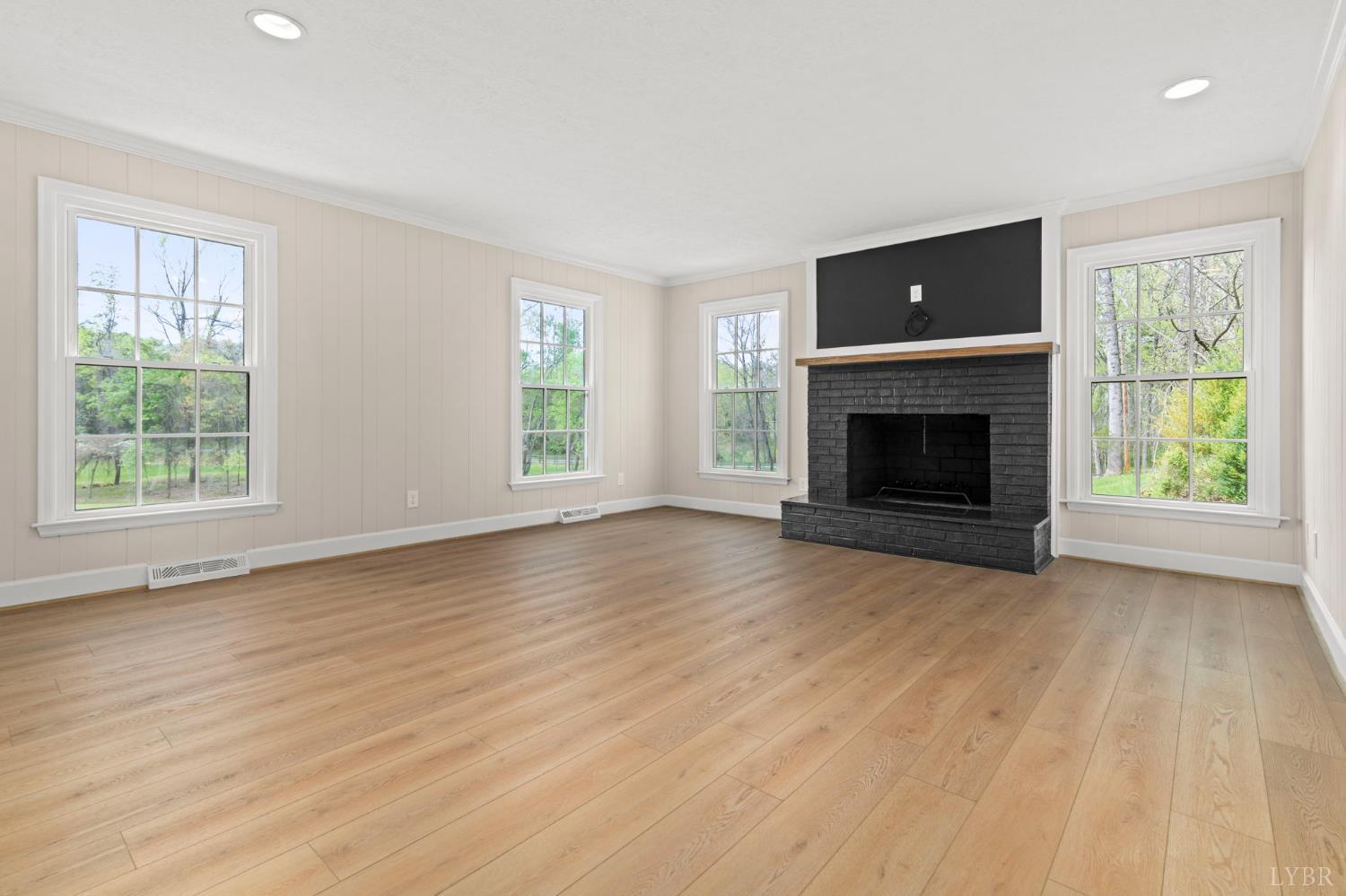 2252 Coffee Road Lynchburg, VA 24503 - Photo 45 of 93 an empty room with windows fireplace and wooden floor