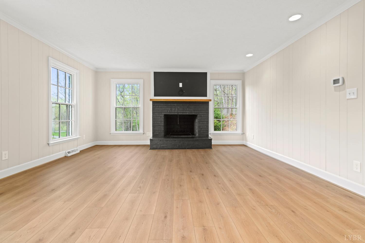 2252 Coffee Road Lynchburg, VA 24503 - Photo 47 of 93 an empty room with windows fireplace and wooden floor