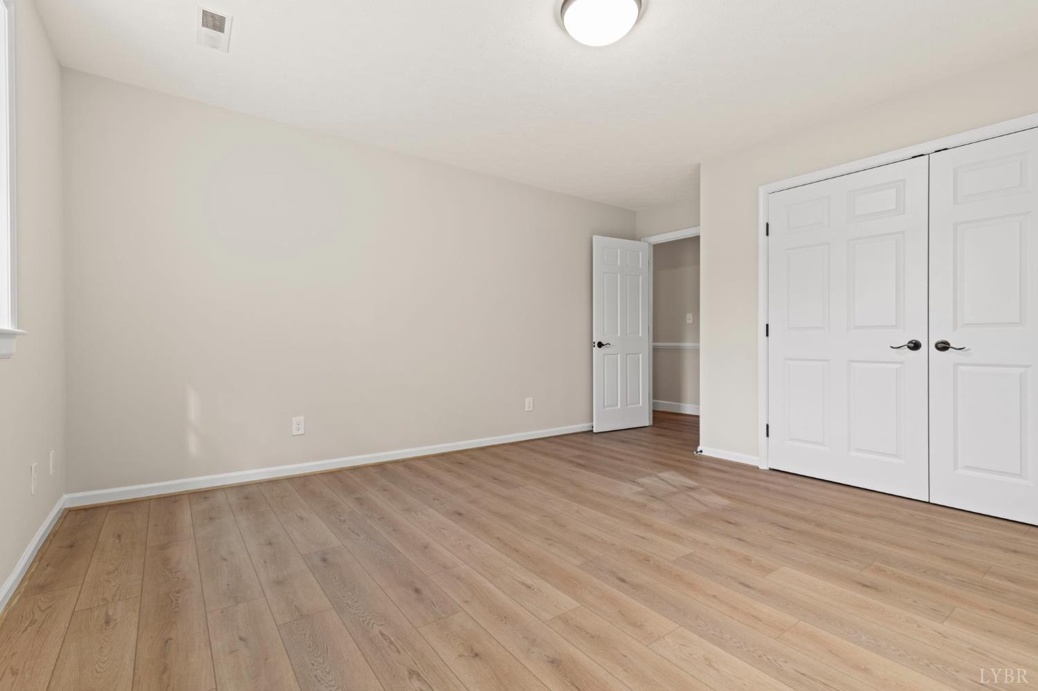 2252 Coffee Road Lynchburg, VA 24503 - Photo 77 of 93 a view of an empty room with wooden floor