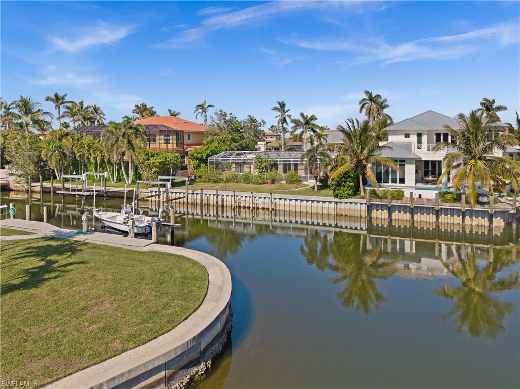 1809 Kingfish Road Naples, FL 34102 - Photo 2 of 8 a view of a swimming pool with a patio
