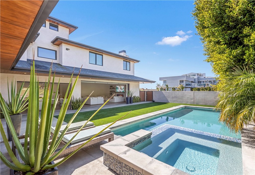 660 Kings Road Newport Beach, CA 92663 - Photo 14 of 41 a view of a backyard with a small swimming pool and sitting area