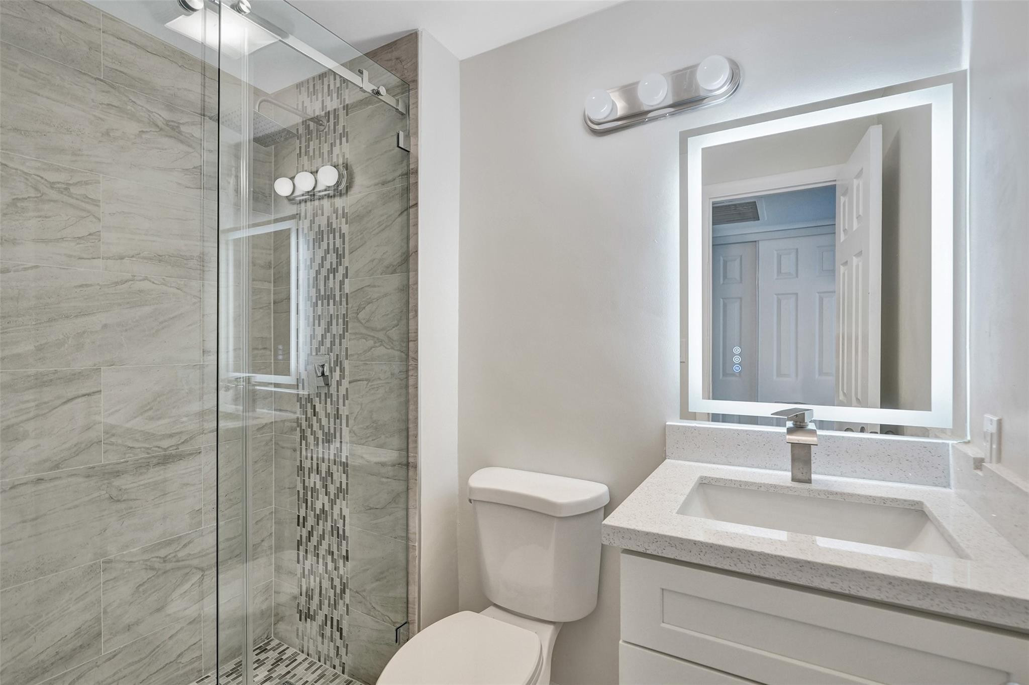 4222 Inverrary Boulevard, Unit 4810 Lauderhill, FL 33319 - Photo 50 of 63 a bathroom with a sink toilet and shower