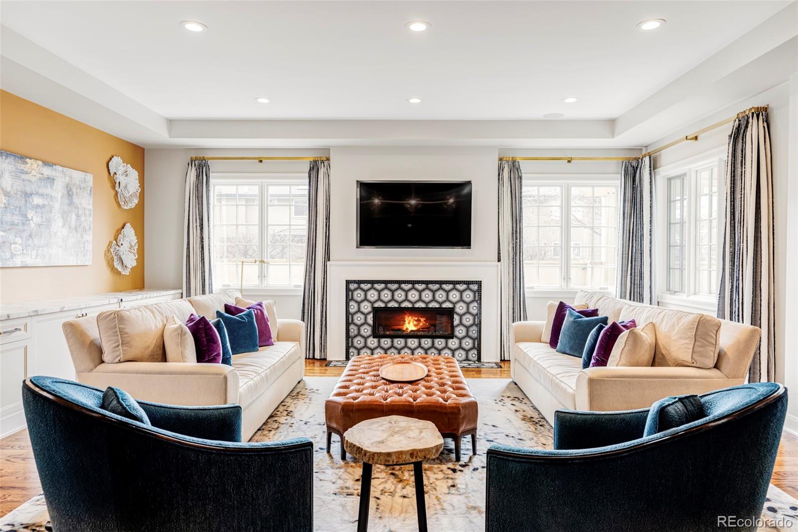 411 Cook Street Denver, CO 80206 - Photo 3 of 40 a living room with fireplace furniture and a flat screen tv