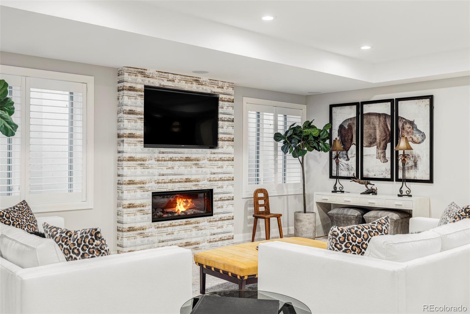 411 Cook Street Denver, CO 80206 - Photo 31 of 40 a living room with furniture a flat screen tv and a fireplace