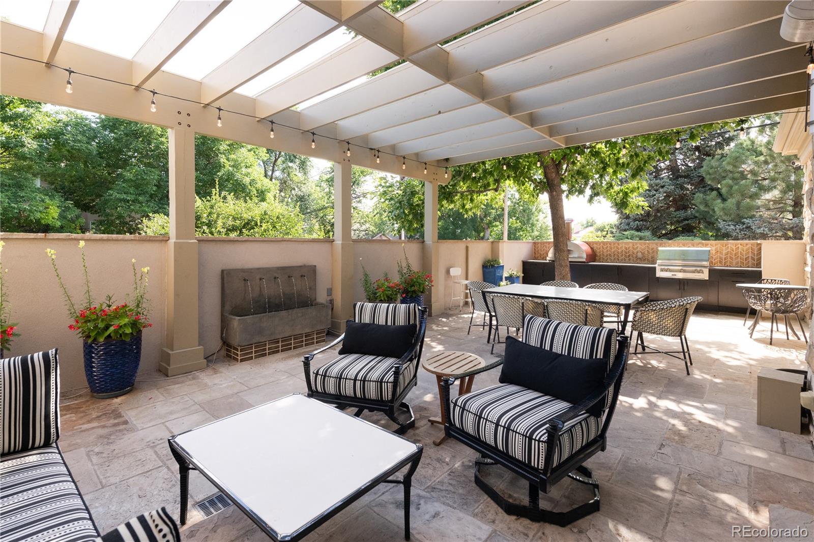 411 Cook Street Denver, CO 80206 - Photo 39 of 40 a view of a patio with a dining table and chairs with wooden floor