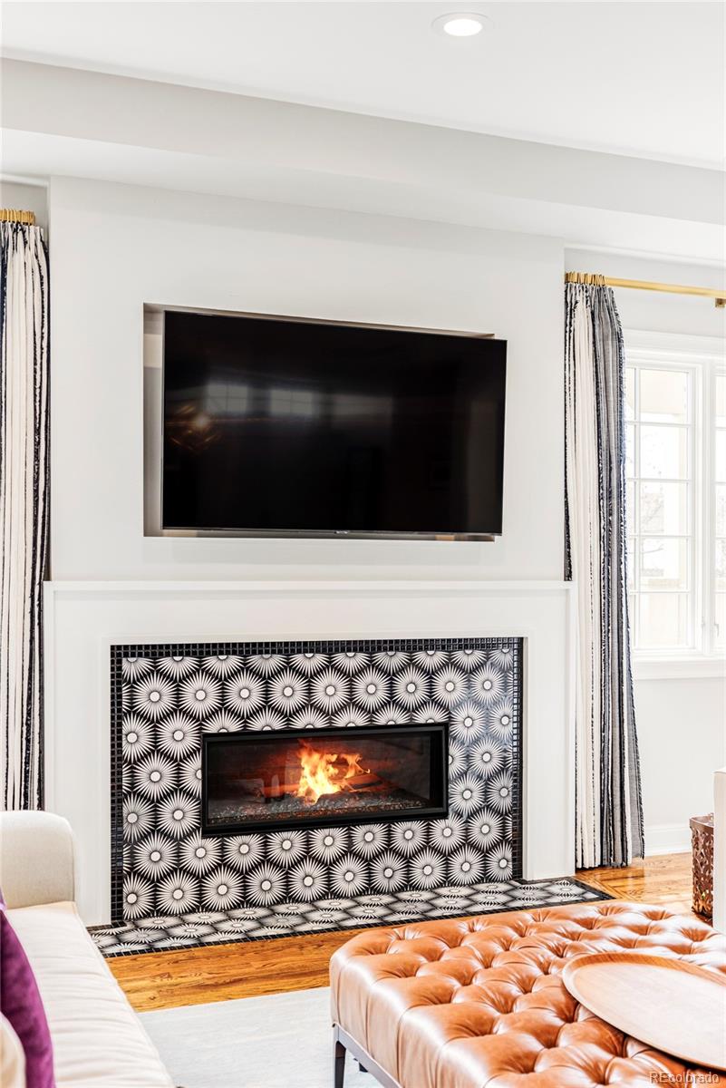 411 Cook Street Denver, CO 80206 - Photo 10 of 40 a living room with flat screen tv and a fireplace