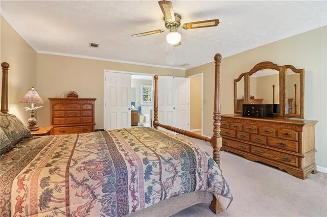 a bathroom with a granite countertop double vanity sink a mirror and a bathtub