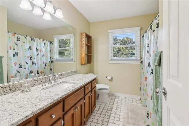 a bedroom with a bed a dresser and a window