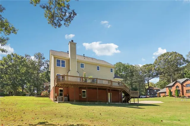 a view of an house with backyard and trees