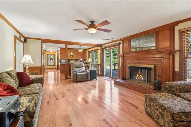 a living room with furniture fireplace and a large window