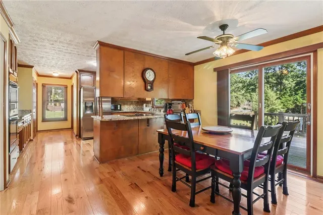 a dining room with furniture a flat screen tv and a large window