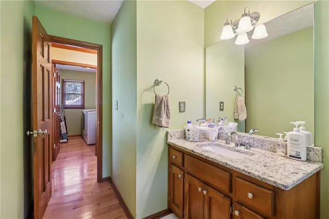 a bathroom with a sink vanity and a mirror