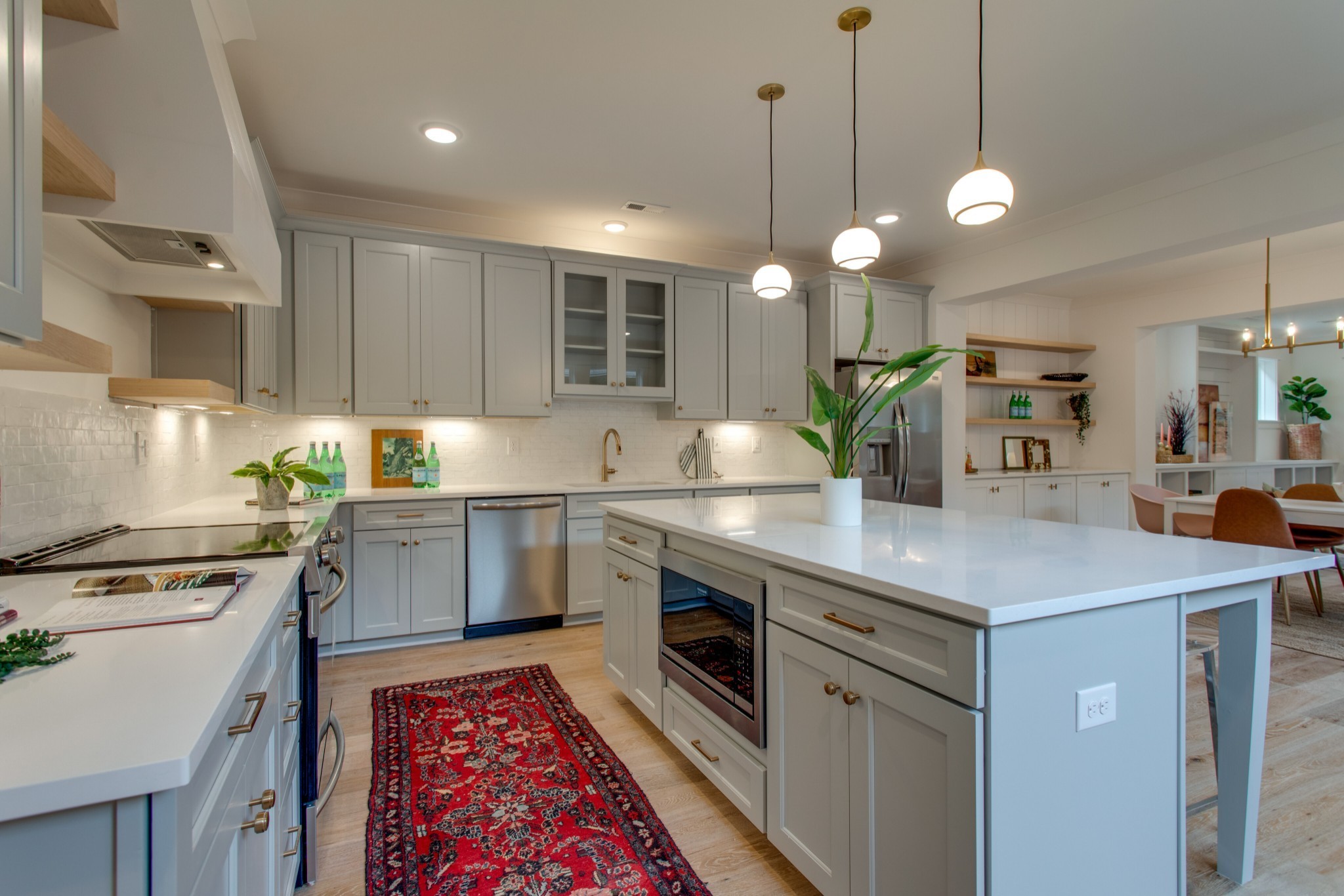 1016 Mitchell Road, Unit B Nashville, TN 37206 - Photo 3 of 29 a kitchen with kitchen island a sink stainless steel appliances and cabinets
