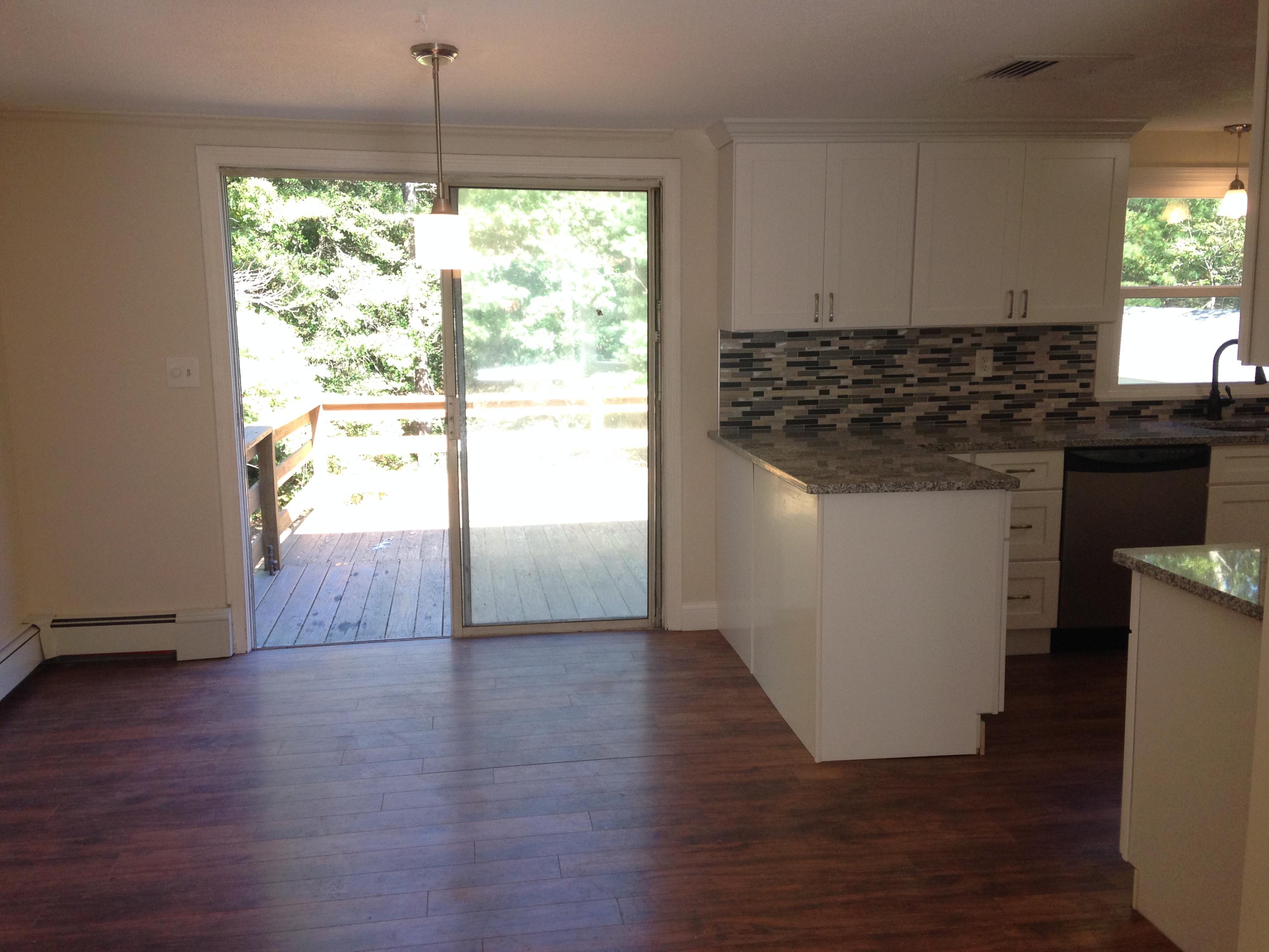 132 Great Marsh Road Centerville, MA 02632 - Photo 8 of 21 a kitchen with granite countertop wooden floors and white appliances