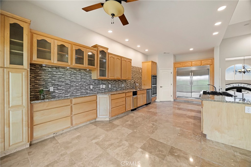 129 Valley Ridge Drive Paradise, CA 95969 - Photo 18 of 66 a large kitchen with stainless steel appliances kitchen island granite countertop a stove and cabinets