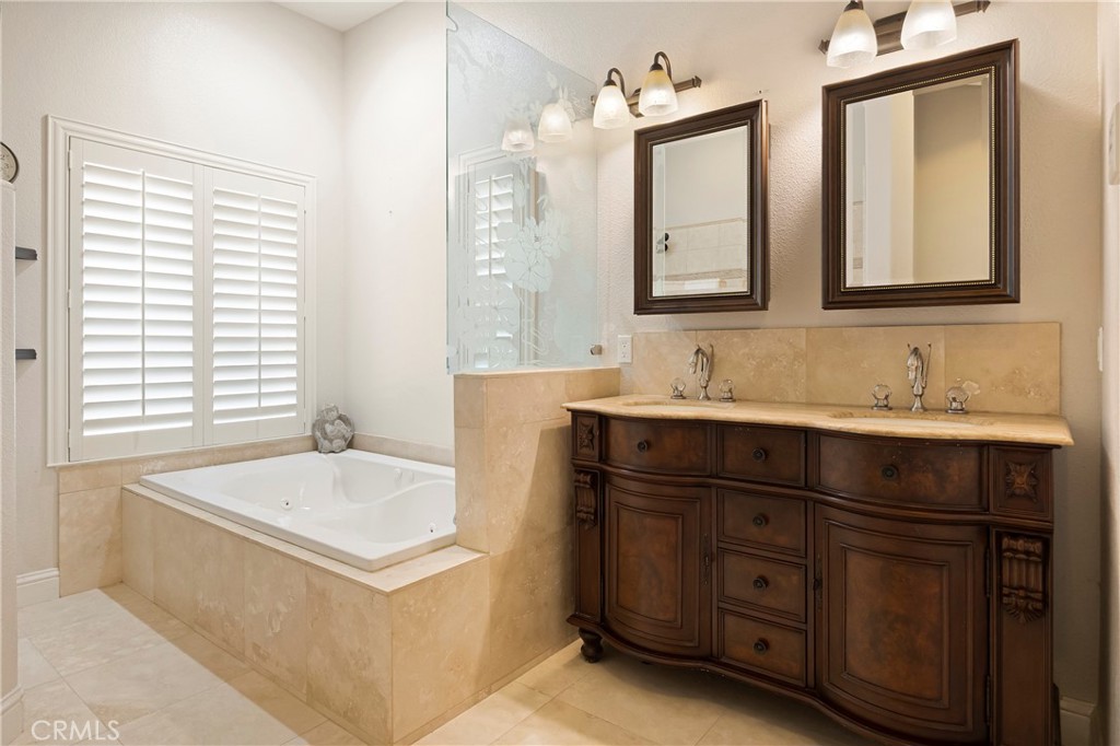 129 Valley Ridge Drive Paradise, CA 95969 - Photo 29 of 66 a bathroom with a tub double vanity sink and mirror
