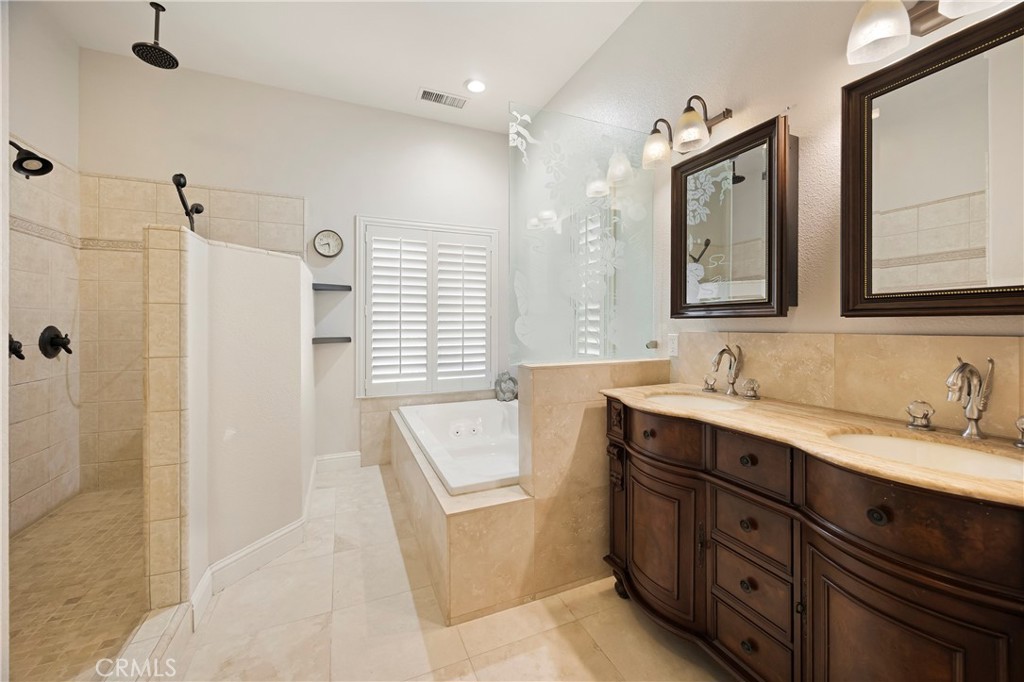 129 Valley Ridge Drive Paradise, CA 95969 - Photo 30 of 66 a bathroom with a double vanity sink a mirror and a shower