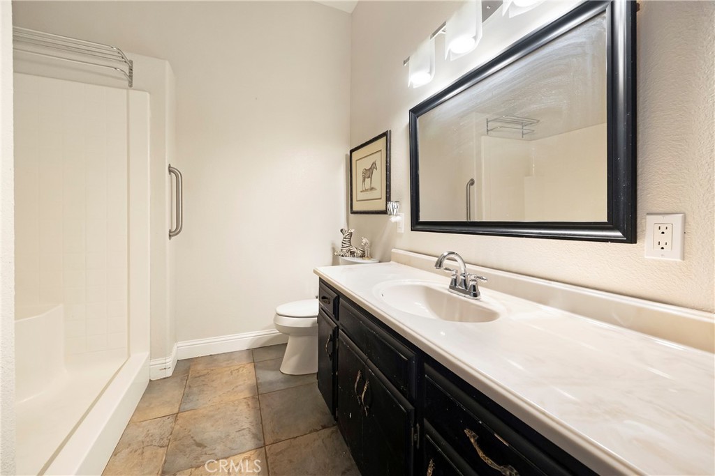 129 Valley Ridge Drive Paradise, CA 95969 - Photo 44 of 66 a bathroom with a sink a toilet and a mirror