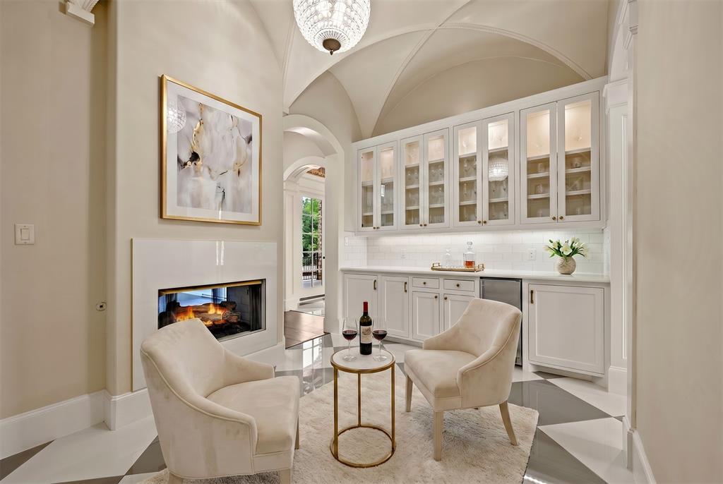 6900 Rockingham Court Colleyville, TX 76034 - Photo 11 of 40 Wine Room/Butler's Pantry. Left View. Not shown is a Bar on right side. Built-in cabinetry with glass-front uppers and a dedicated wine refrigerator and ice maker. Ai staged.