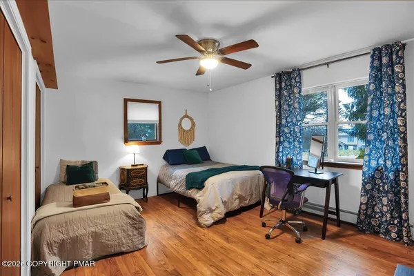 a bedroom with two beds and a window