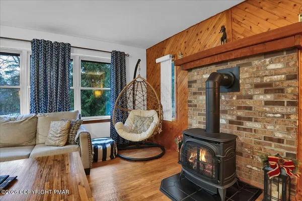 a living room with furniture a window and wooden floor
