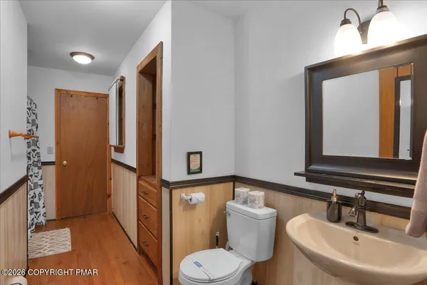 a bathroom with a toilet sink and mirror