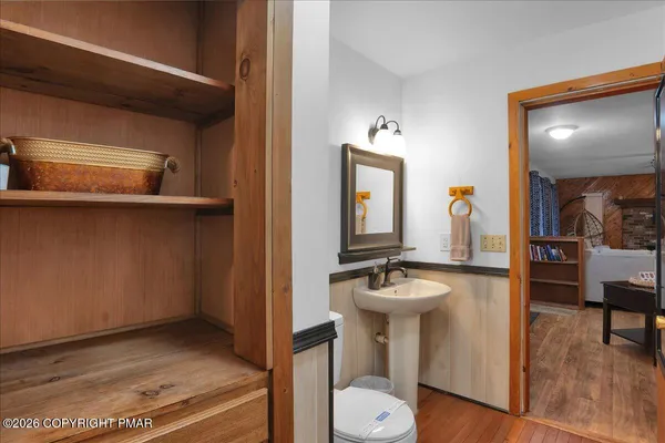 a bathroom with a sink a toilet and a mirror