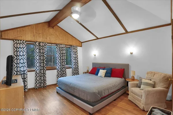 a bedroom with a bed and a couch