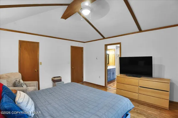 a bedroom with a bed and a flat screen tv